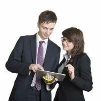 Business man and woman looking at a tablet